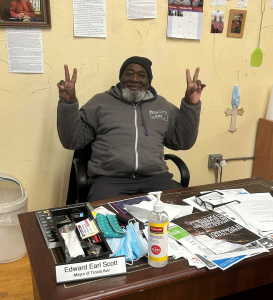 Ed at his desk, filled with notes, drawings, and memories of friends and former clients.