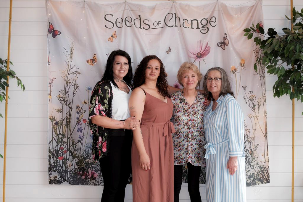 Reva, Taffny, Caity in front of a seeds of change banner